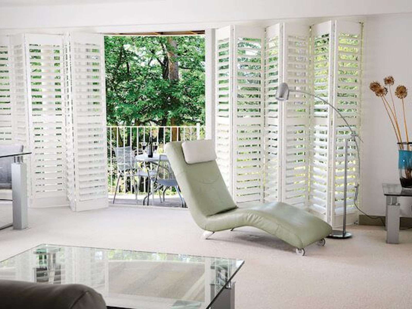 Tracked bi-fold shutters across a wide patio door